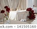 Elegant wedding reception table decorated with red roses and white candles  141505160