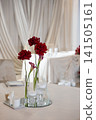 Elegant wedding reception table decoration featuring red roses and candles 141505161
