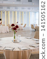 Elegant wedding reception table with floral centerpiece and soft lighting 141505162