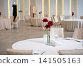 Elegant wedding reception decoration with floral centerpieces and round tables 141505163