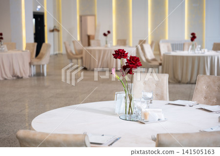 Elegant wedding reception decoration with floral centerpieces and round tables Elegant wedding reception decoration with floral centerpieces and round tables 141505163