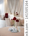 Elegant wedding reception table with red flowers and decorative elements 141505164