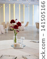Elegant wedding reception table setting with red flowers and glassware 141505166