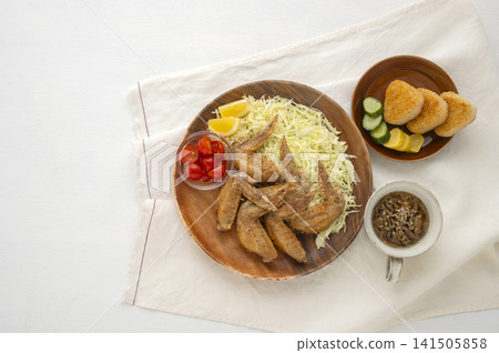 A home-style Japanese lunch set featuring fragrant fried chicken wings and grilled rice balls. A home-style Japanese lunch set featuring fragrant fried chicken wings and grilled rice balls. 141505858