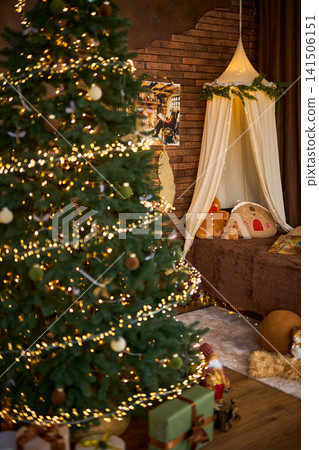 Cozy Christmas Interior with Lighted Tree and Canopy Bed Cozy Christmas Interior with Lighted Tree and Canopy Bed 141506151