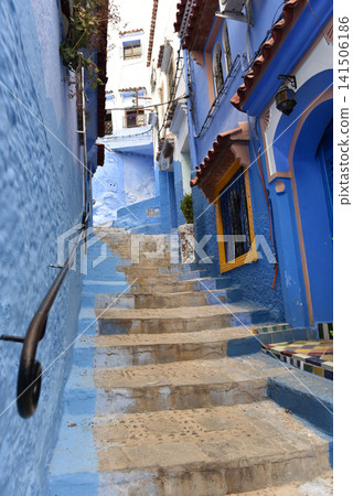 Old blue stone stairs ascending past traditional buildings in Chefchaouen Medina, Morocco Old blue stone stairs ascending past traditional buildings in Chefchaouen Medina, Morocco 141506186