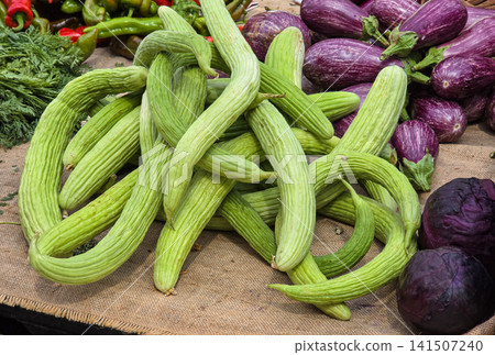 Fresh organic Armenian cucumbers, purple eggplants, and red cabbage at a Mediterranean farmers market in the daytime Fresh organic Armenian cucumbers, purple eggplants, and red cabbage at a Mediterranean farmers market in the daytime 141507240