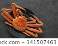 A luxurious boiled snow crab served on a black plate. 141507463