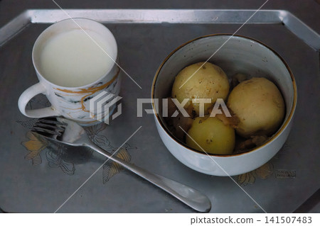Boiled potatoes with meat and milk on a tray 141507483
