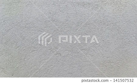Close up of a hand troweled light gray concrete wall with granular bumps and swirling patterns, creating a neutral, utilitarian surface texture. Close up of a hand troweled light gray concrete wall with granular bumps and swirling patterns, creating a neutral, utilitarian surface texture. 141507532