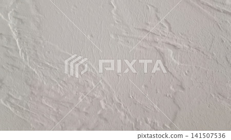 Close up abstract of an off white rough surface with ridges, valleys, and cracks creating a three dimensional pattern resembling dried, cracked plaster or texture. Close up abstract of an off white rough surface with ridges, valleys, and cracks creating a three dimensional pattern resembling dried, cracked plaster or texture. 141507536