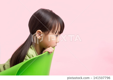 Side view of curious child resting chin on chair, copy space for child psychology and education concept Side view of curious child resting chin on chair, copy space for child psychology and education concept 141507796