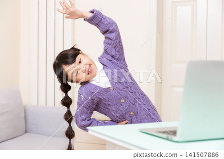 Asian Elementary School Girl Doing Stretching Exercise at Home, Online Learning and Healthy Lifestyle Concept Asian Elementary School Girl Doing Stretching Exercise at Home, Online Learning and Healthy Lifestyle Concept 141507886