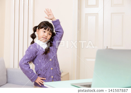 Asian Elementary School Girl Doing Stretching Exercise at Home, Online Learning and Healthy Lifestyle Concept Asian Elementary School Girl Doing Stretching Exercise at Home, Online Learning and Healthy Lifestyle Concept 141507887