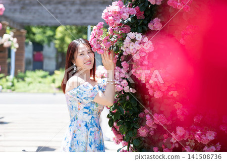 A woman leaning against a rose. A woman leaning against a rose. 141508736