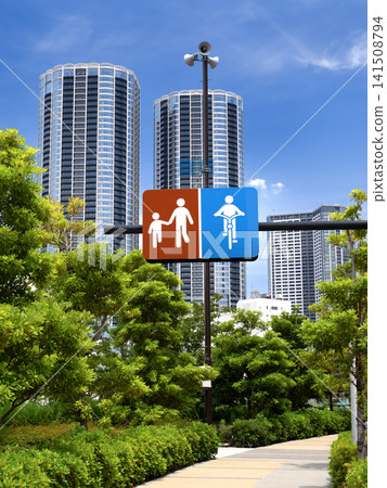 Pedestrian and bicycle priority road signs and high-rise apartment buildings in Tokyo. Pedestrian and bicycle priority road signs and high-rise apartment buildings in Tokyo. 141508794
