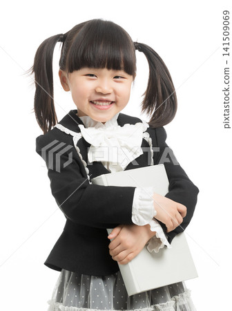 Happy Asian schoolgirl hugging a textbook and laughing, academic achievement and love for school. Happy Asian schoolgirl hugging a textbook and laughing, academic achievement and love for school. 141509069