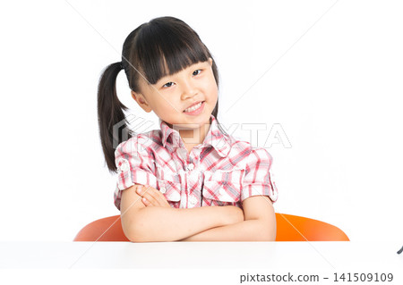 An Asian elementary school student happily studying at a study desk., back to school concept 141509109