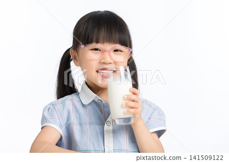 Happy child holding a glass of milk for healthy growth 141509122