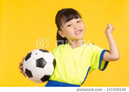 A high-energy portrait of the same East Asian girl on a solid yellow backdrop, holding the soccer ball aloft with one hand while cheering excitedly and raising her other fist in a victorious gesture, A high-energy portrait of the same East Asian girl on a solid yellow backdrop, holding the soccer ball aloft with one hand while cheering excitedly and raising her other fist in a victorious gesture, 141509140