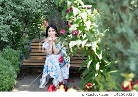 A woman sitting on a bench A woman sitting on a bench 141509326