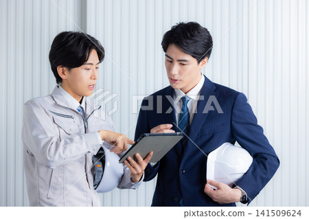 A businessman wearing work clothes A businessman wearing work clothes 141509624