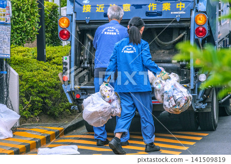 A glimpse of garbage collection work on a street corner in Yokohama, Japan... = Yokohama City A glimpse of garbage collection work on a street corner in Yokohama, Japan... = Yokohama City 141509819