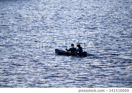 2 people on a small boat 2 people on a small boat 141510089