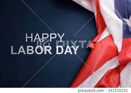 Celebrating Happy Labor Day with an American flag folded over a dark wooden surface with copy space. High Quality Photo Celebrating Happy Labor Day with an American flag folded over a dark wooden surface with copy space. High Quality Photo 141510191