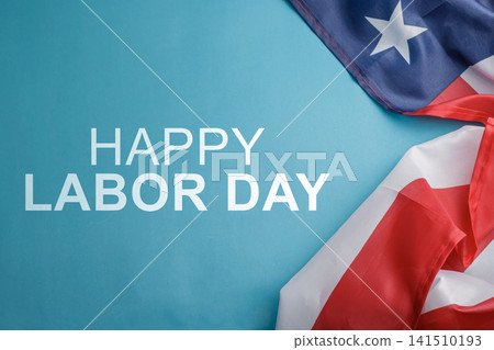 Bright blue background featuring text Happy Labor Day and a draped American flag with copy space. High Quality Photo Bright blue background featuring text Happy Labor Day and a draped American flag with copy space. High Quality Photo 141510193
