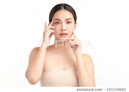 A beautiful young Asian woman with clean, fresh skin against a white background. Skincare, facial treatment, cosmetology, beauty, and spa. An elegant portrait of an Asian woman. A beautiful young Asian woman with clean, fresh skin against a white background. Skincare, facial treatment, cosmetology, beauty, and spa. An elegant portrait of an Asian woman. 141510682