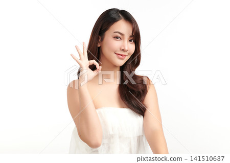 A beautiful young Asian woman with clean, fresh skin against a white background. Skincare, facial treatment, cosmetology, beauty, and spa. An elegant portrait of an Asian woman. A beautiful young Asian woman with clean, fresh skin against a white background. Skincare, facial treatment, cosmetology, beauty, and spa. An elegant portrait of an Asian woman. 141510687