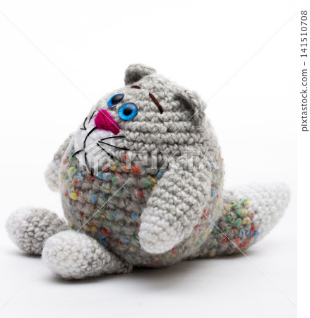 Knitted  cat on a white background 141510708