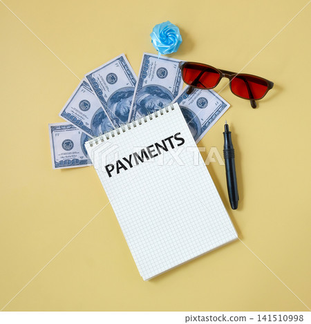 Text PAYMENTS on notepad paper on color background. Text PAYMENTS on notepad paper on color background. 141510998