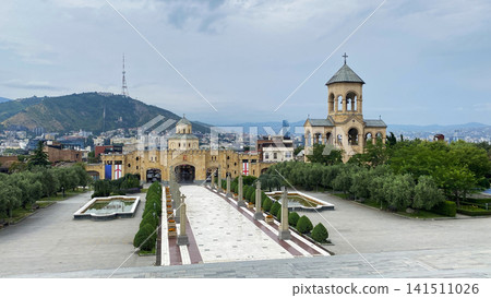 Holy Trinity Cathedral complex opens across a formal courtyard in Tbilisi, with its ceremonial gate, bell tower Holy Trinity Cathedral complex opens across a formal courtyard in Tbilisi, with its ceremonial gate, bell tower 141511026