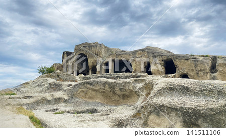 Rock-cut facade at Uplistsikhe features open chambers and supporting columns across a sandstone slope in Georgia, Rock-cut facade at Uplistsikhe features open chambers and supporting columns across a sandstone slope in Georgia, 141511106