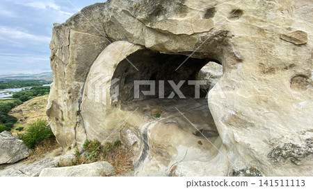 Rock-hewn room at Uplistsikhe shows an ancient sheltered living space shaped inside sandstone above the Georgian valley Rock-hewn room at Uplistsikhe shows an ancient sheltered living space shaped inside sandstone above the Georgian valley 141511113