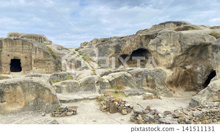 Camera surveys Uplistsikhe caves in wide view, revealing rock-cut chambers and ancient passages in Georgia Camera surveys Uplistsikhe caves in wide view, revealing rock-cut chambers and ancient passages in Georgia 141511131