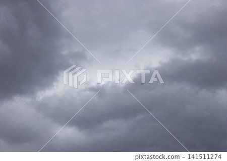 Soft Gray Storm Clouds with a Pale Opening in a Full Frame Overcast Sky Soft Gray Storm Clouds with a Pale Opening in a Full Frame Overcast Sky 141511274