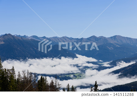 Green Farmland Revealed Between Valley Fog Banks Below Kronplatz Ridges Green Farmland Revealed Between Valley Fog Banks Below Kronplatz Ridges 141511288