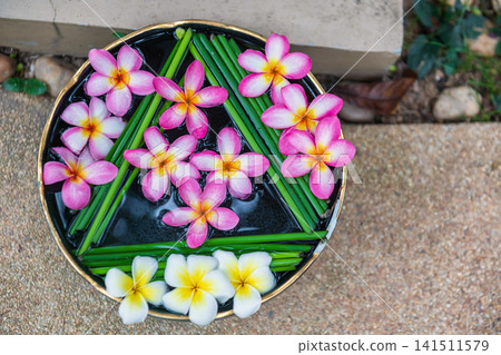 Plumeria float on water in jar decor at outdoor garden in hotel 141511579