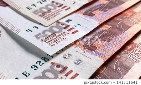 Banknotes of 5000 rubles. A close-up of a part of a five-thousand-ruble banknote. The Russian national currency. Cash banknotes. Background of cash ruble notes. Banknotes of 5000 rubles. A close-up of a part of a five-thousand-ruble banknote. The Russian national currency. Cash banknotes. Background of cash ruble notes. 141511641