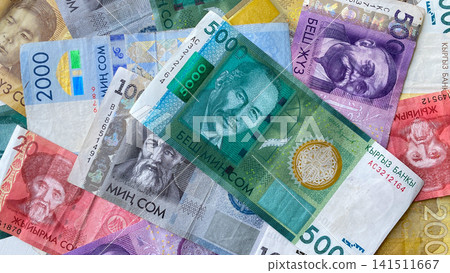 Beautiful colored background of different Kyrgyz national currency. Banknotes in 5000, 1000, 2000, 500, 200 and 20 som, current money of Kyrgyzstan. Cash banknotes. Beautiful colored background of different Kyrgyz national currency. Banknotes in 5000, 1000, 2000, 500, 200 and 20 som, current money of Kyrgyzstan. Cash banknotes. 141511667