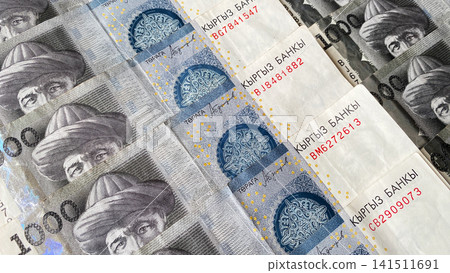 Kyrgyz banknotes in 1000 SOM. The Kyrgyz national currency is one thousand som. Cash banknotes of Kyrgyzstan. Financial business background concept. Kyrgyz banknotes in 1000 SOM. The Kyrgyz national currency is one thousand som. Cash banknotes of Kyrgyzstan. Financial business background concept. 141511691