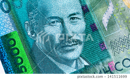 A close-up of the portrait of the Kyrgyz Soviet actor Suymenkul Chokmorov on a 5000 SOM bill. Kyrgyz national currency. Cash banknotes of Kyrgyzstan. A close-up of the portrait of the Kyrgyz Soviet A close-up of the portrait of the Kyrgyz Soviet actor Suymenkul Chokmorov on a 5000 SOM bill. Kyrgyz national currency. Cash banknotes of Kyrgyzstan. A close-up of the portrait of the Kyrgyz Soviet 141511699