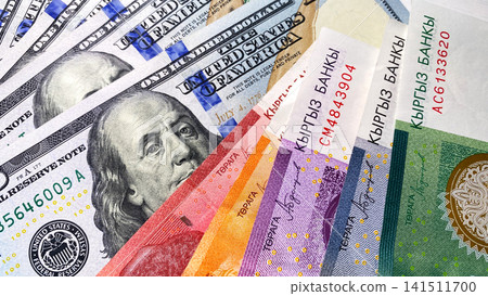 Currency exchange. 100 dollar bills and Kyrgyz money of different denominations. American and Kyrgyz national currencies. Cash banknotes of the USA and Kyrgyzstan. Currency exchange. 100 dollar bills and Kyrgyz money of different denominations. American and Kyrgyz national currencies. Cash banknotes of the USA and Kyrgyzstan. 141511700