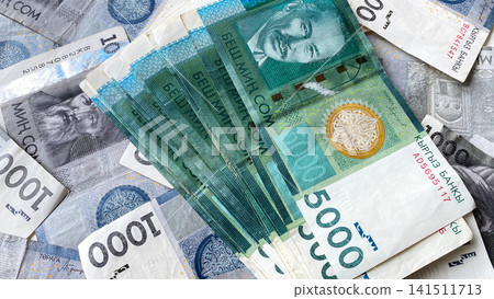 Money in 5000 SOM is on 1000 som bills. Economics and finance. Kyrgyz national currency. Economics and finance. The current money of Kyrgyzstan. Money in 5000 SOM is on 1000 som bills. Economics and finance. Kyrgyz national currency. Economics and finance. The current money of Kyrgyzstan. 141511713