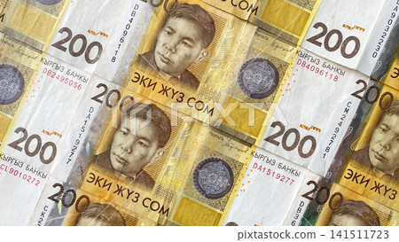 Kyrgyz banknotes of 200 SOM are laid out exactly on the table. Cash banknotes of Kyrgyzstan. Background of the Kyrgyz national currency. Kyrgyz banknotes of 200 SOM are laid out exactly on the table. Cash banknotes of Kyrgyzstan. Background of the Kyrgyz national currency. 141511723