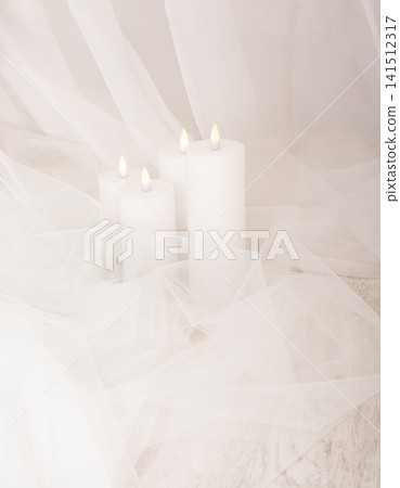 Four white wax candles in delicate white tulle and veil Four white wax candles in delicate white tulle and veil 141512317