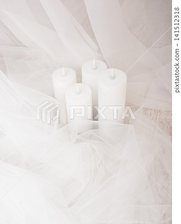 Top view of group of white candles among airy fabric Top view of group of white candles among airy fabric 141512318